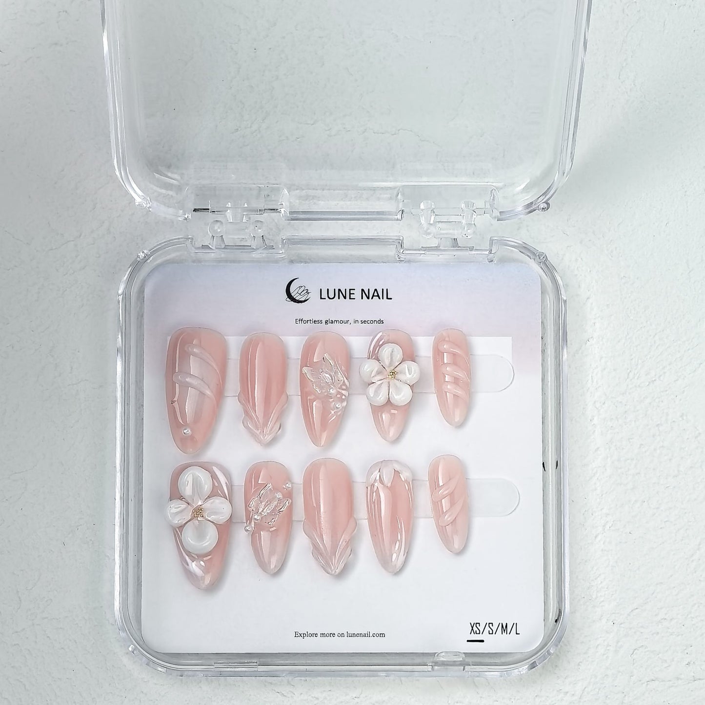LUNE NAIL clear case displaying floral pink press-on nails in XS S M L sizes